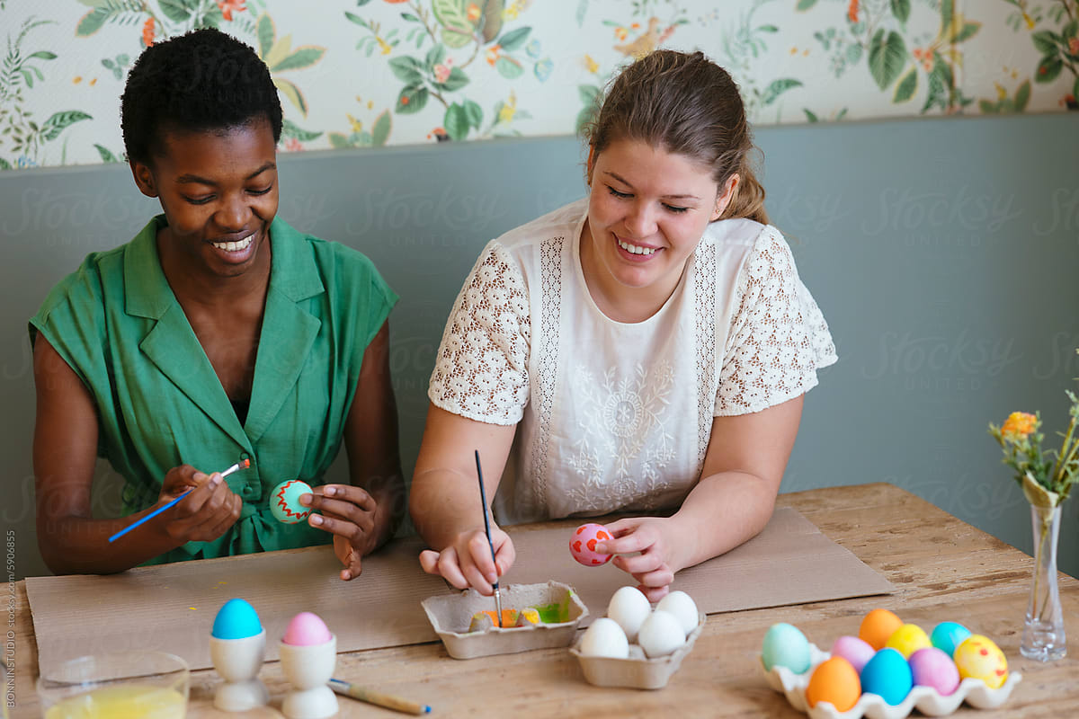 Female friends preparing eggs for Easter