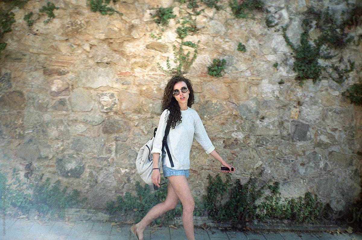 Young Woman Walking Against Stone Wall By Stocksy Contributor Amor Burakova Stocksy 4683