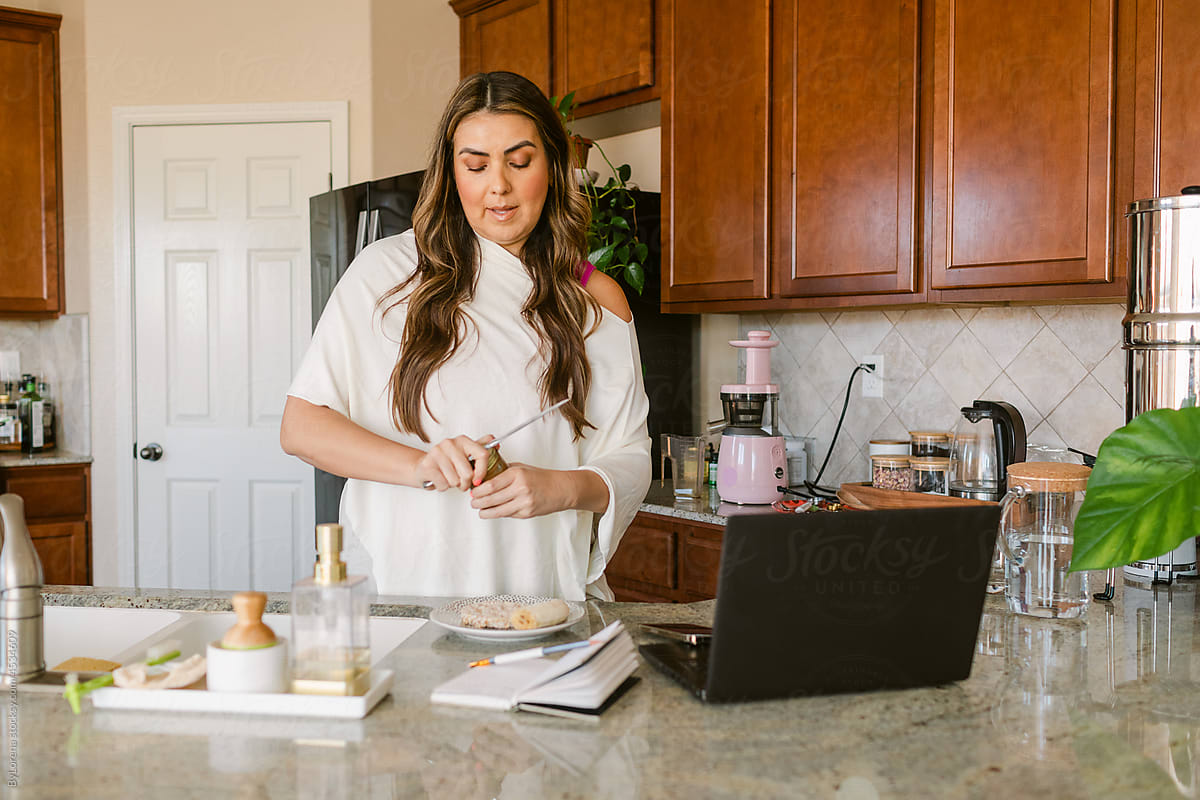 Contemporary woman preparing breakfast in kitchen