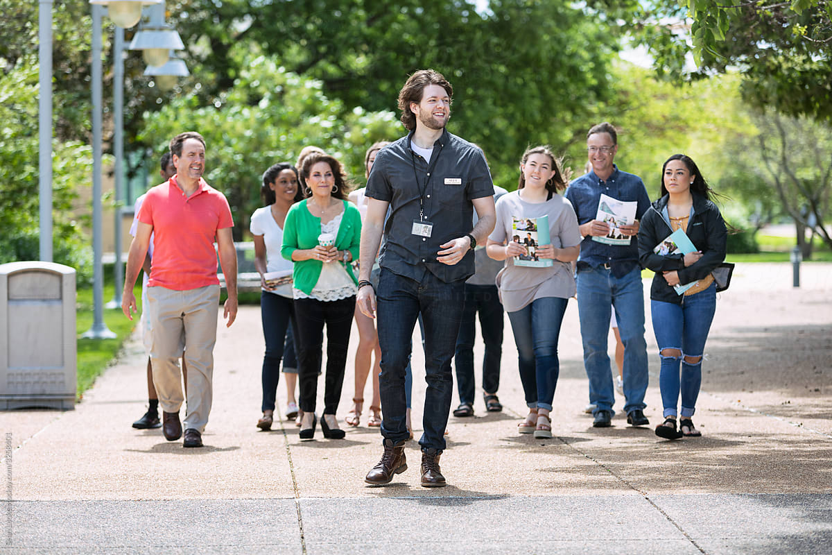 Tour: Guide Leads Group Through College Campus