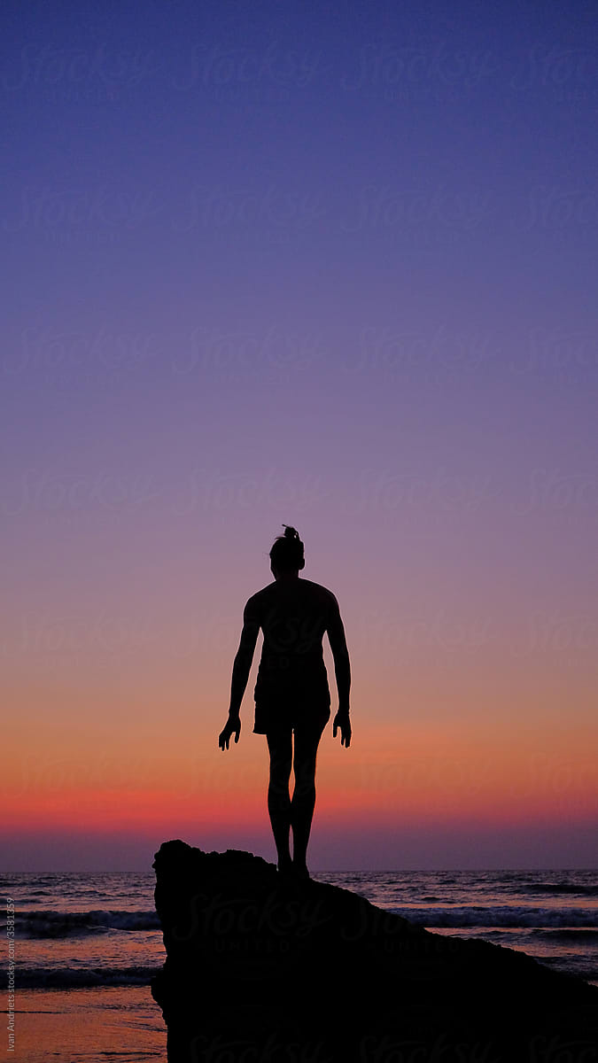Sunset silhouette portrait of a young tall man