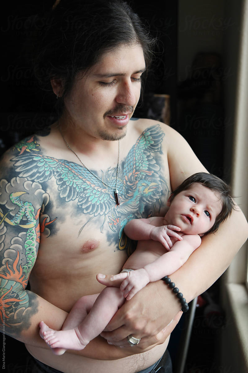 Dark Haired Father Holding Baby in Diaper