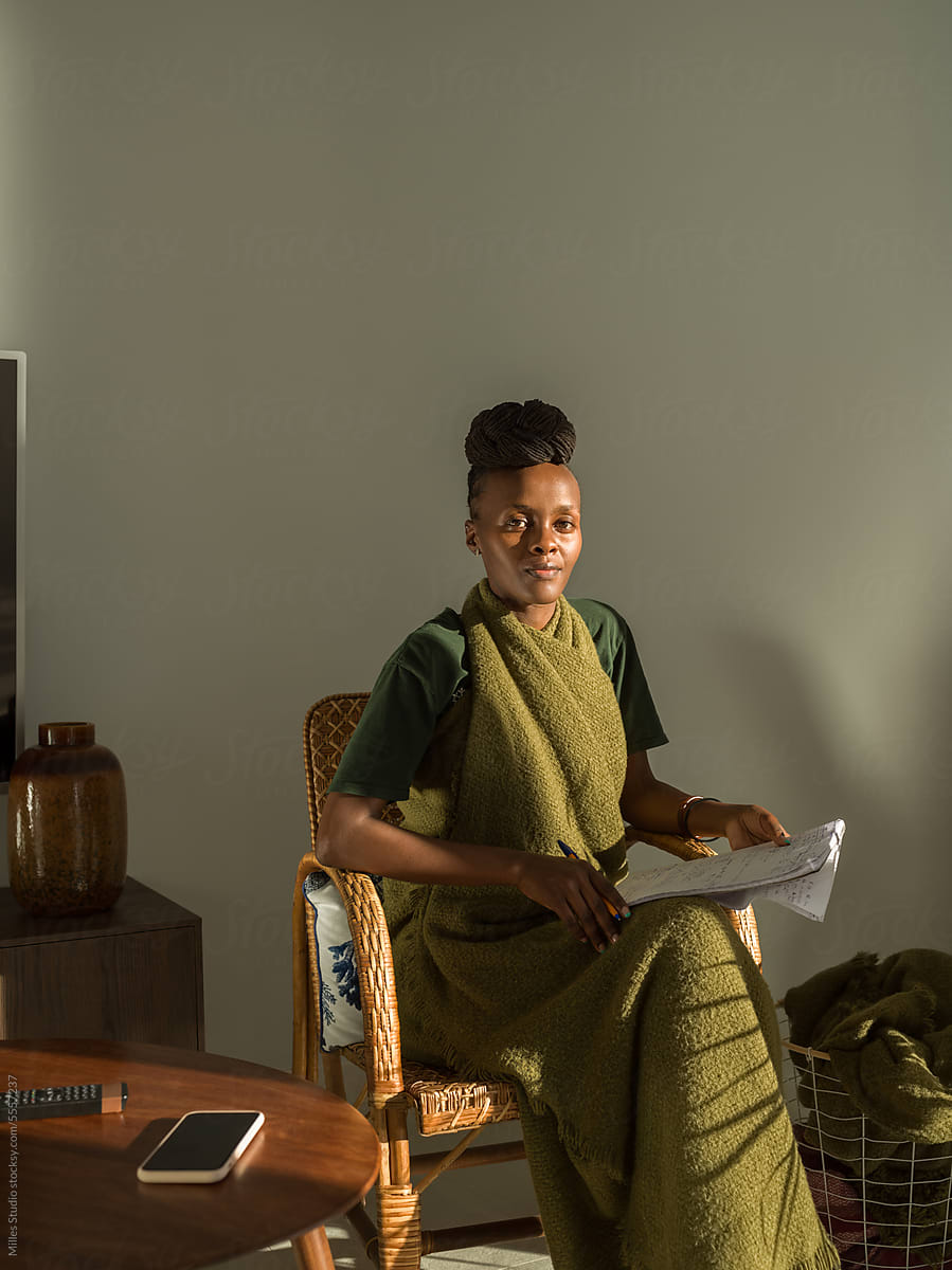 Black female linguist studying in light lounge