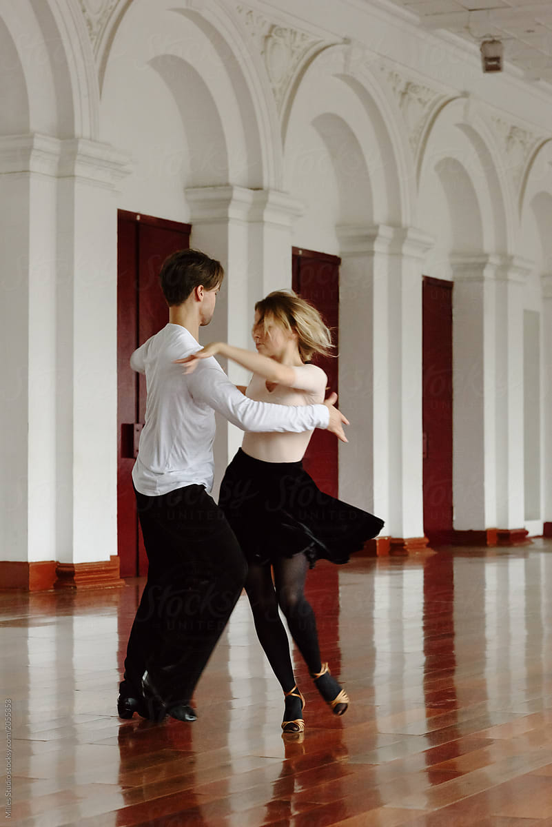 Dynamic dancing couple in ballroom