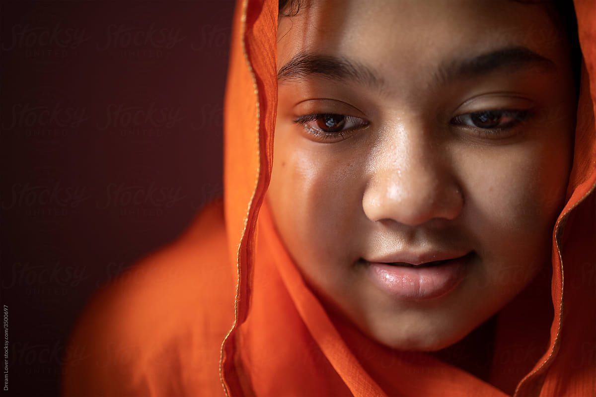 Teenage girl under veil with smiling facial expression