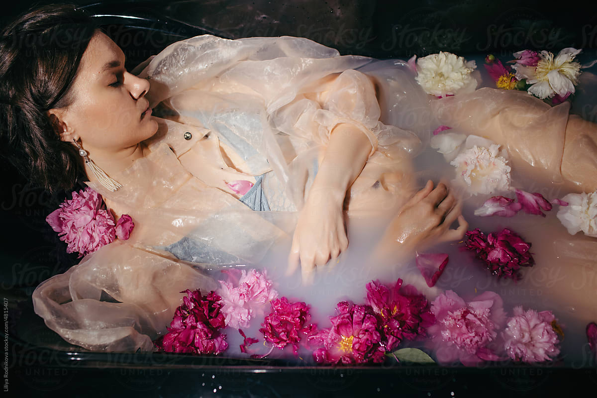 Sleeping beauty in bath with flowers