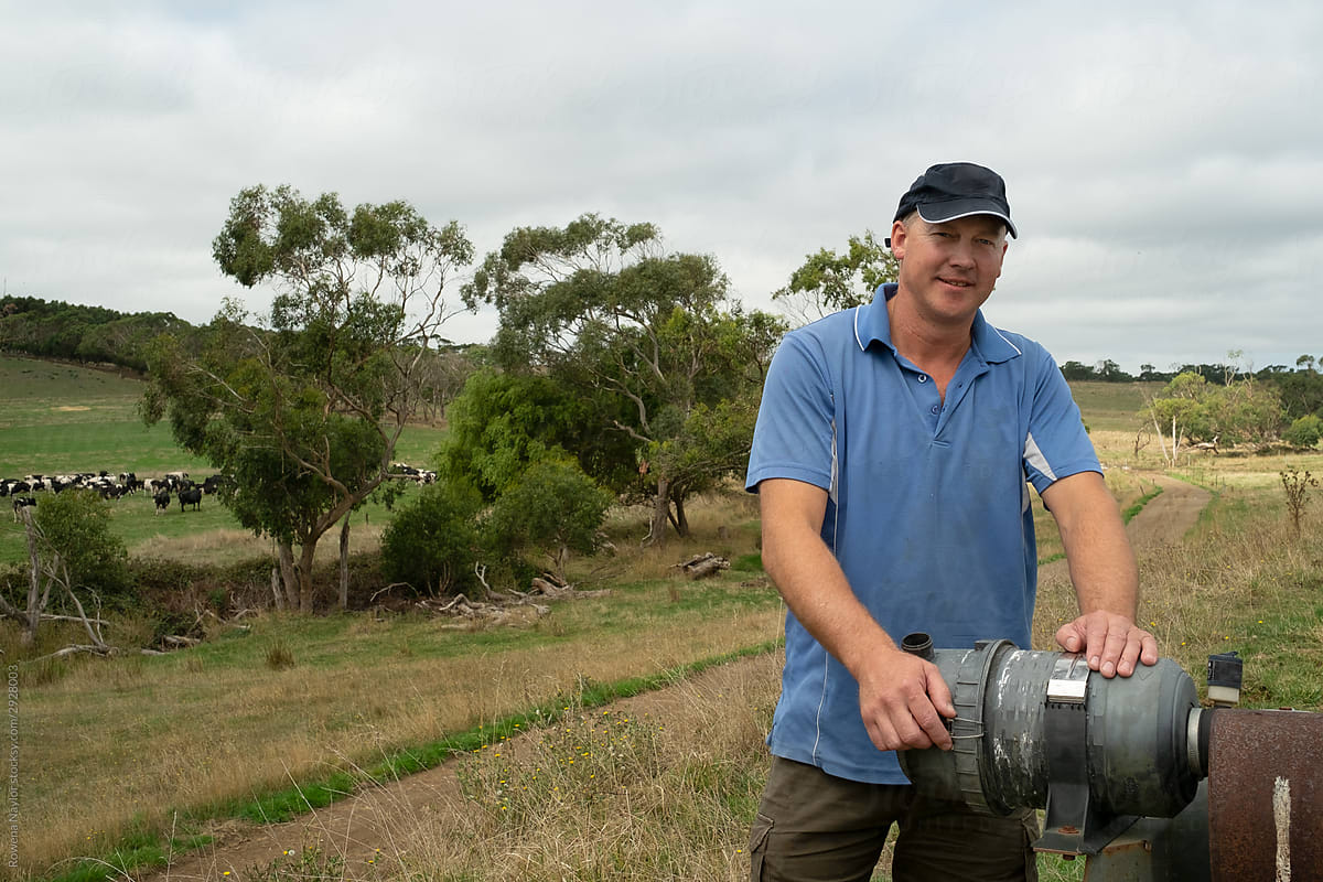 Dairy farmer standing next to water pump station on farm