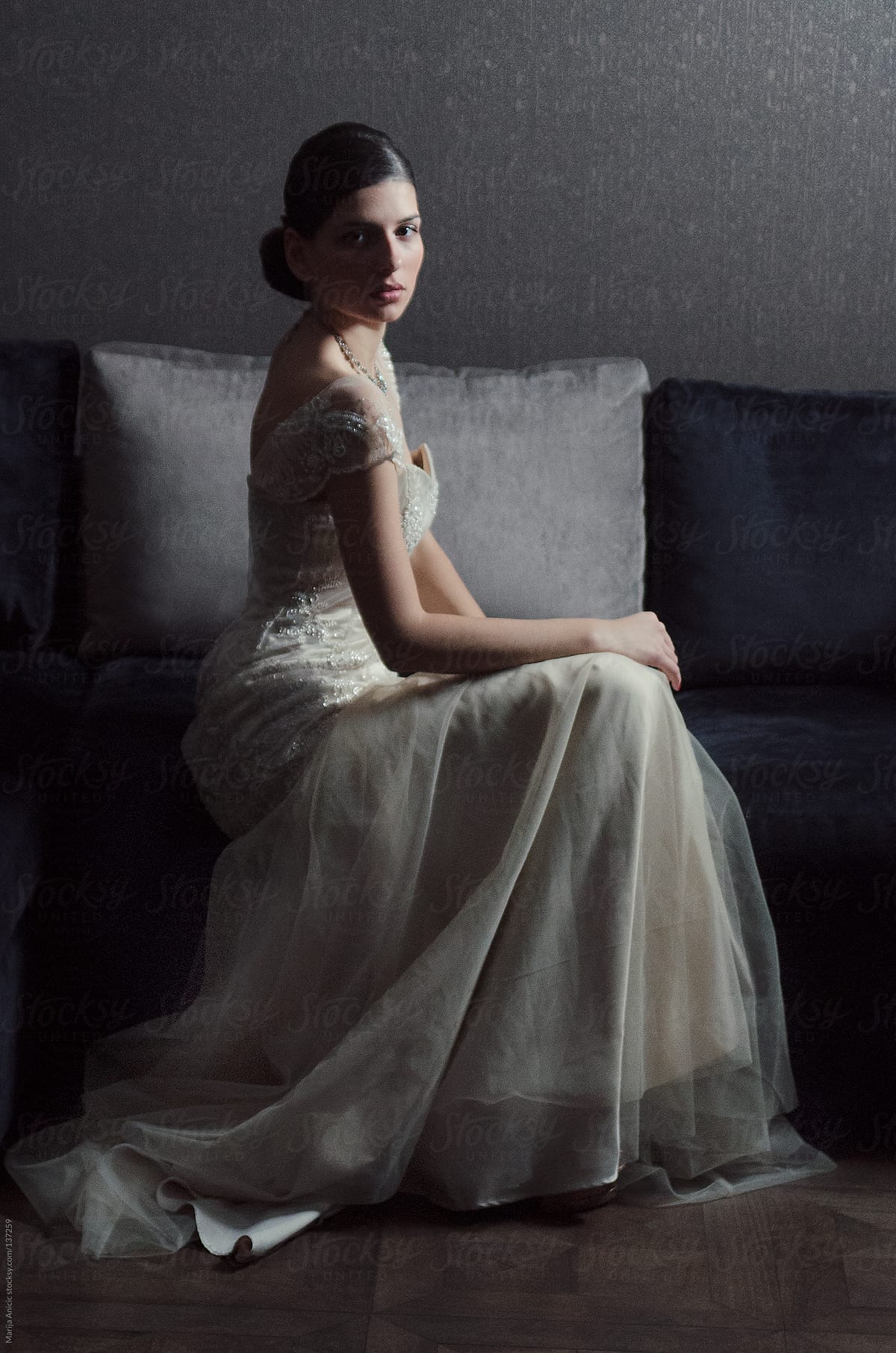 Beautiful brunette bride in white wedding dress ,indoor