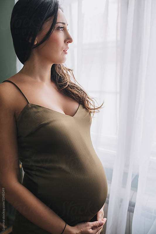 Pregnant Woman Standing by the Window