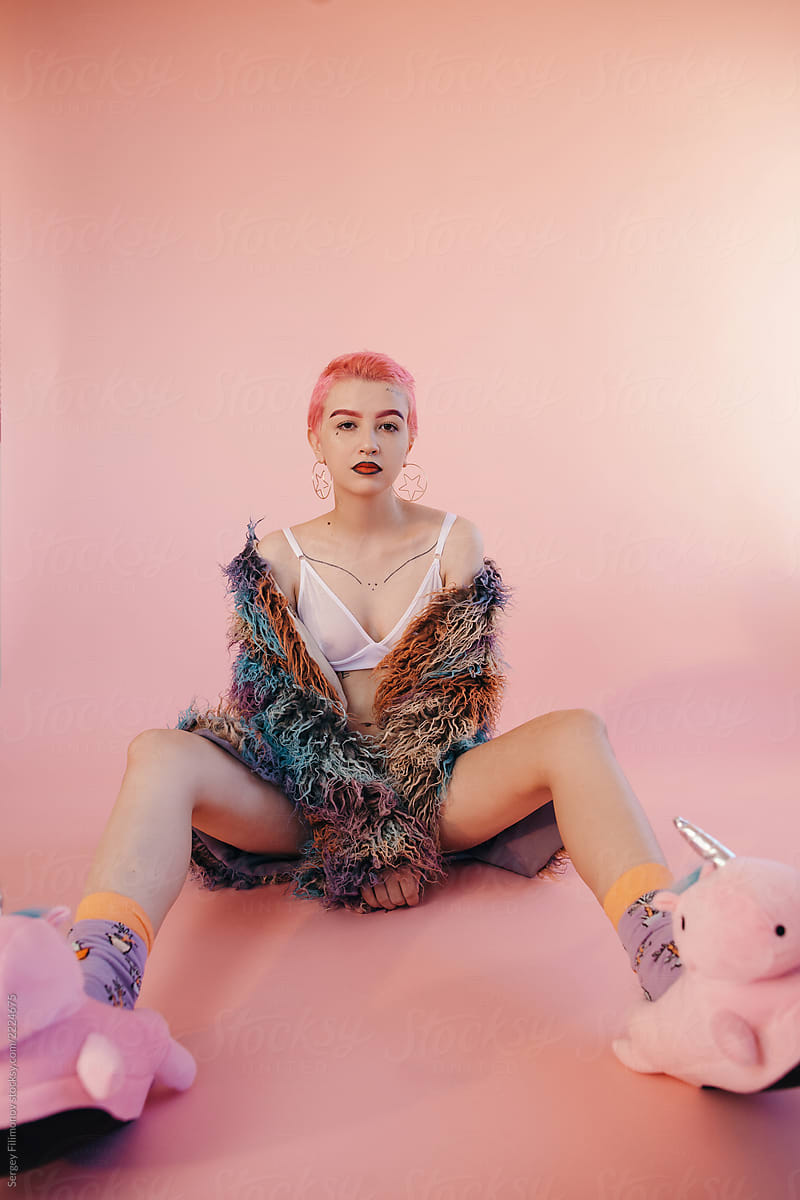 Sensual model in jacket and unicorn slippers