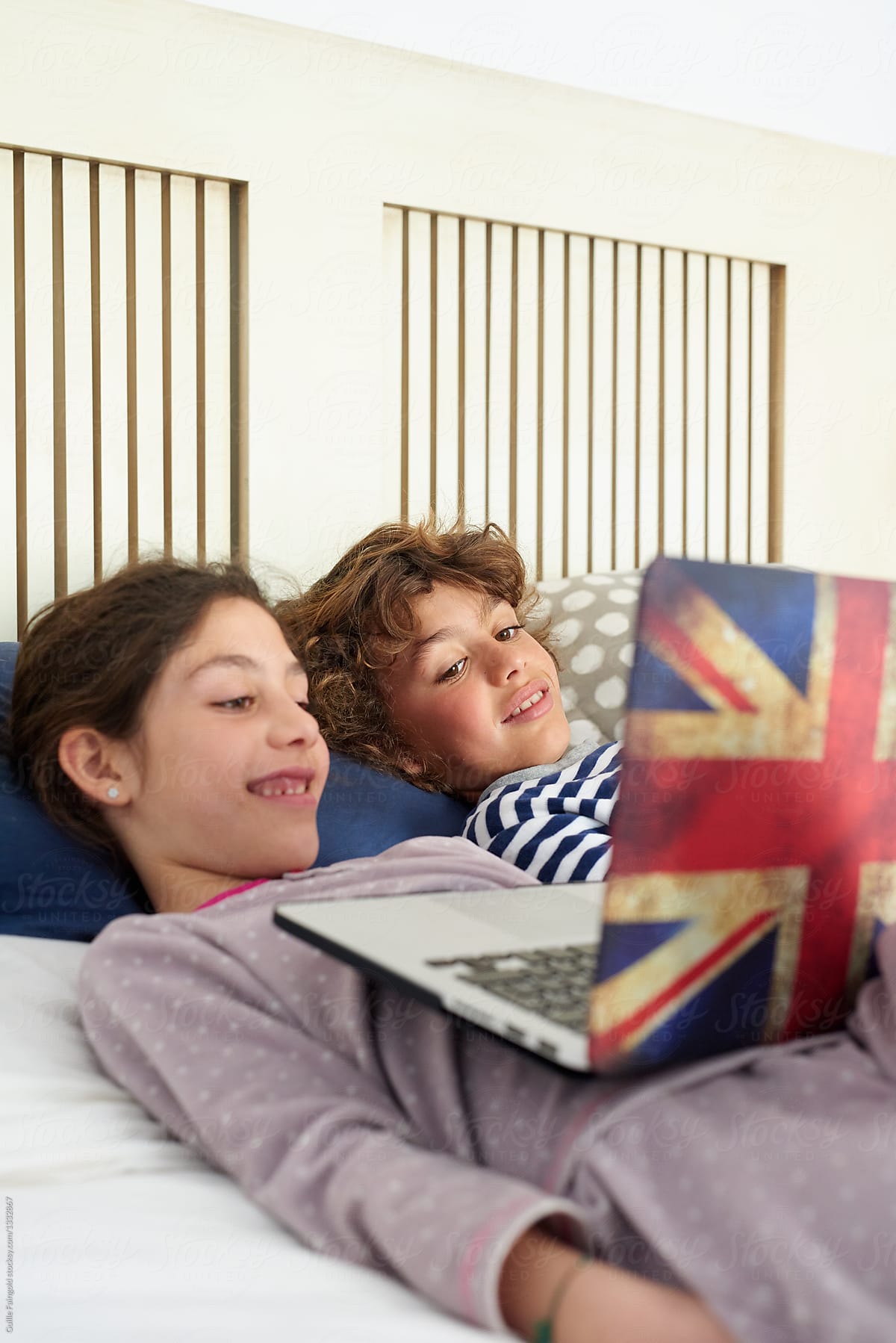 Siblings watching cartoons on laptop