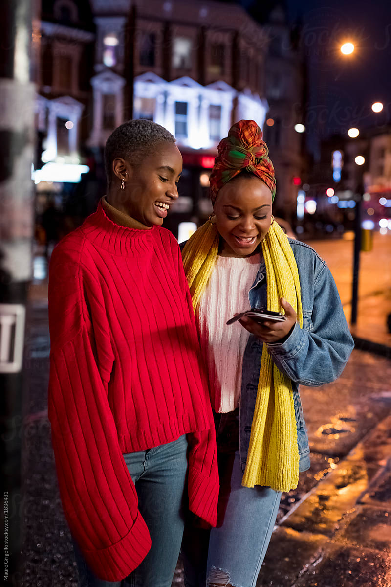 Black women using a mobile phone during nightlife