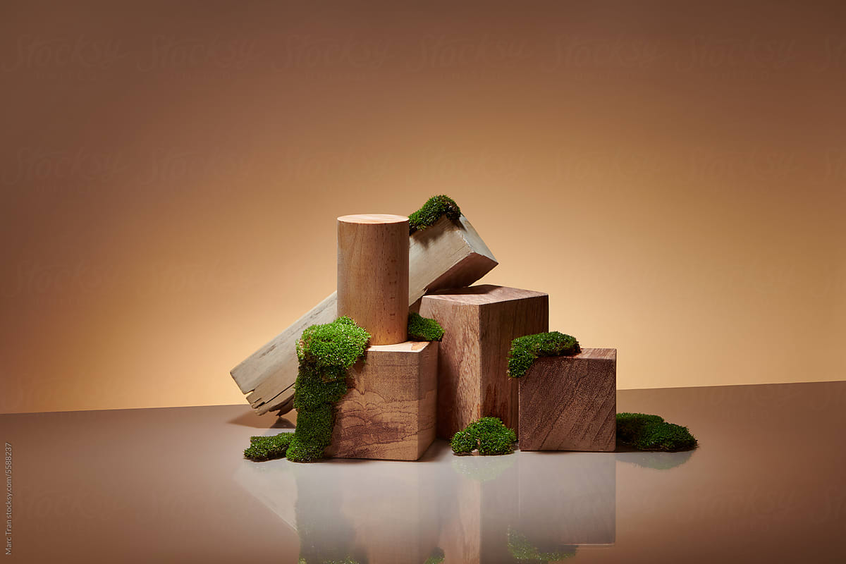 Some wooden podiums or display stands with green moss