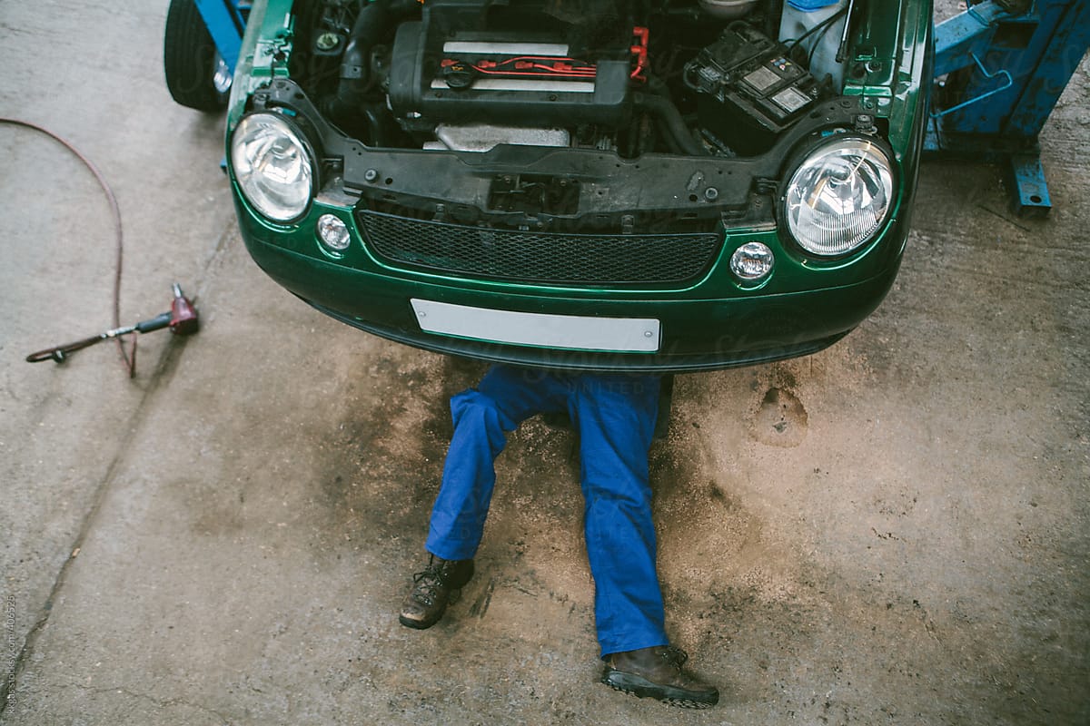 A mechanic under a car