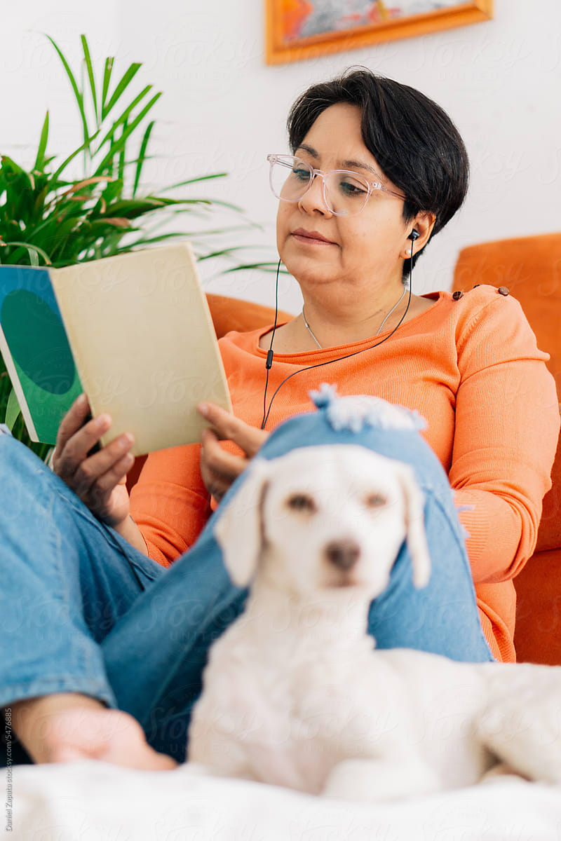 Woman reading with her pet.