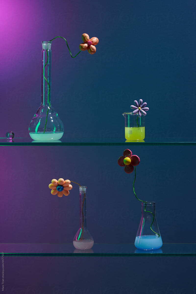 Glass laboratory tubes and flasks of pastel liquid