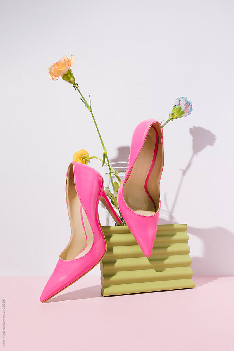 Female high heel sandals and colorful spring flowers.