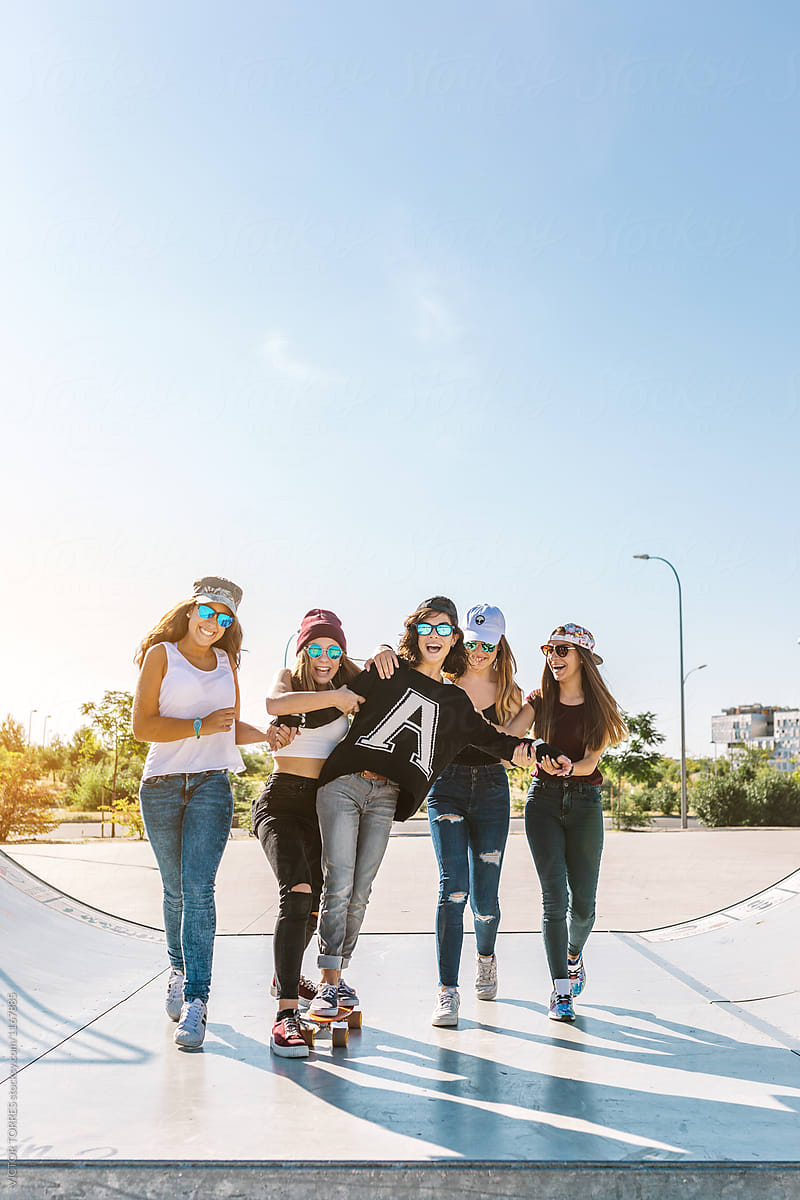 Girls having fun with a skateboard.