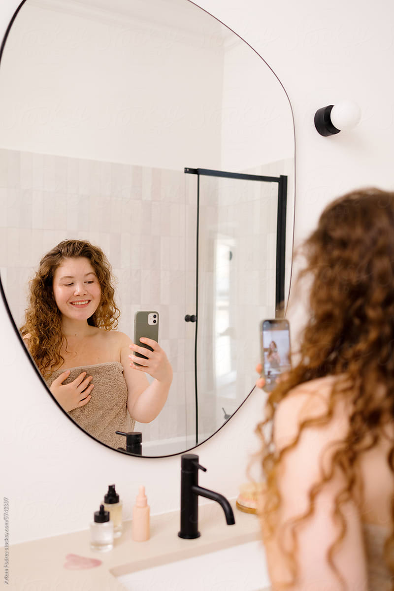 A woman is take photo  in the mirror Self-Care Routine
