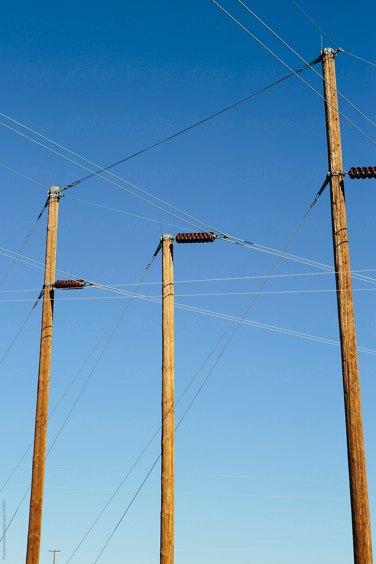 Electrical power lines against blue sky