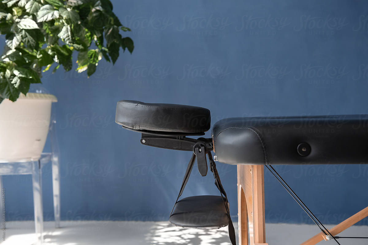 Massage table with headrest and arm sling