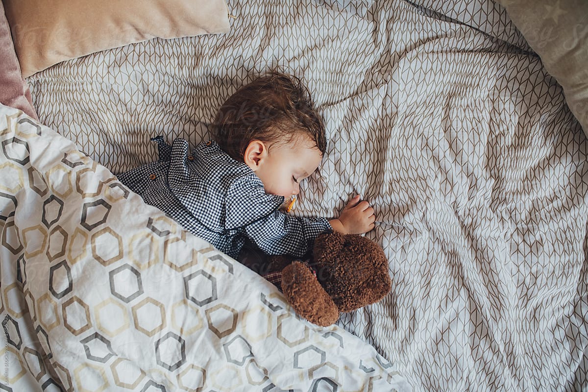 cute baby sleeping with teddy