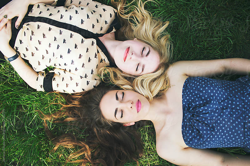 Two Female Friends Are Lying On Grass By Jovana Rikalo Stocksy United
