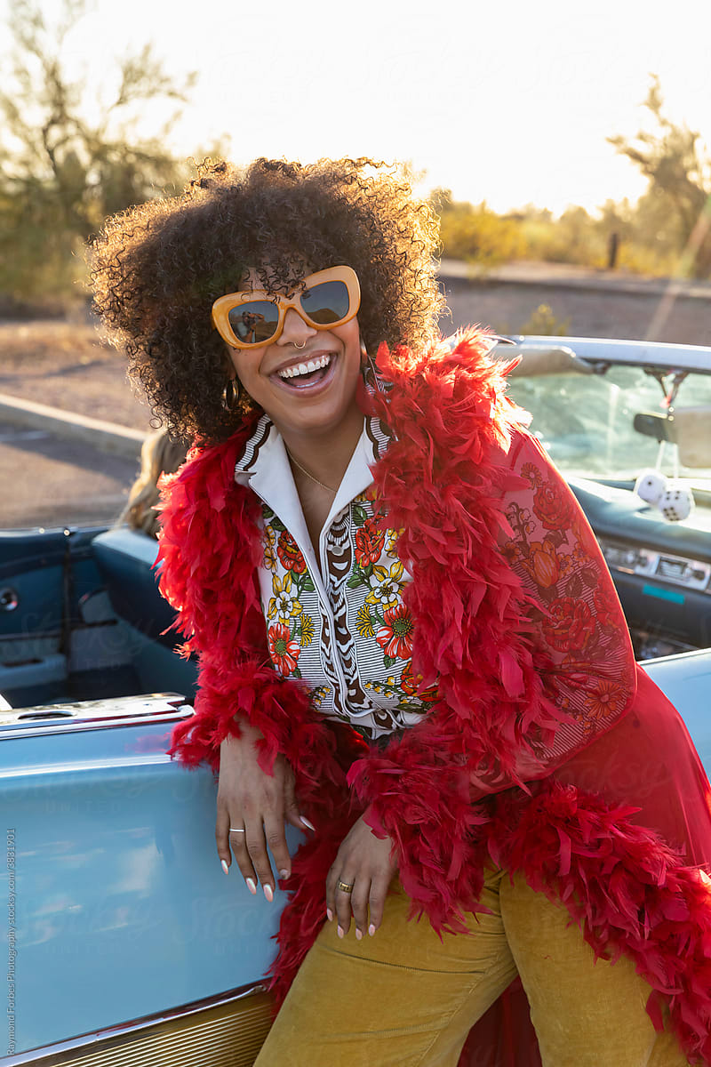 African American Woman next to Vintage American car with big Smile