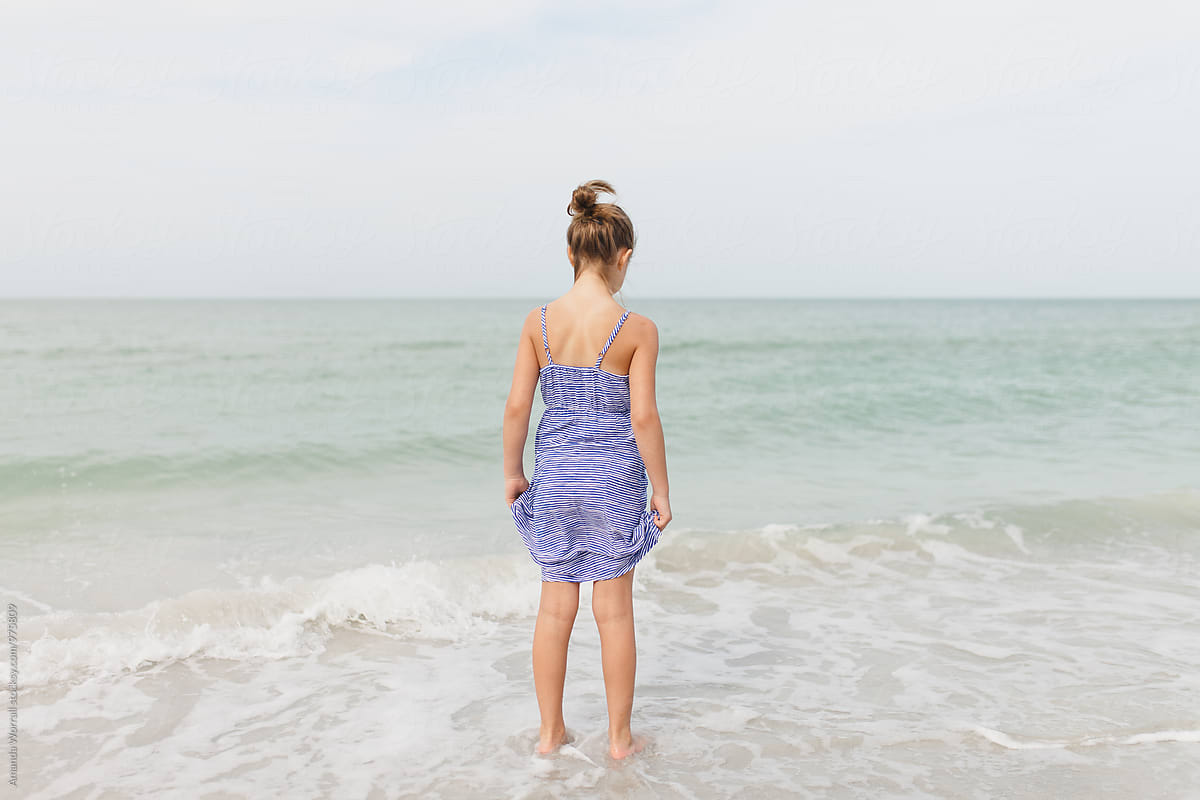 Preteen Girl Standing In The Ocean Shot From Behind By Stocksy Contributor Amanda Worrall 1417