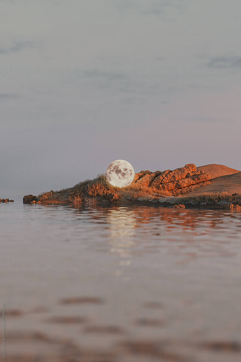 A moon living through a landscape at sunset