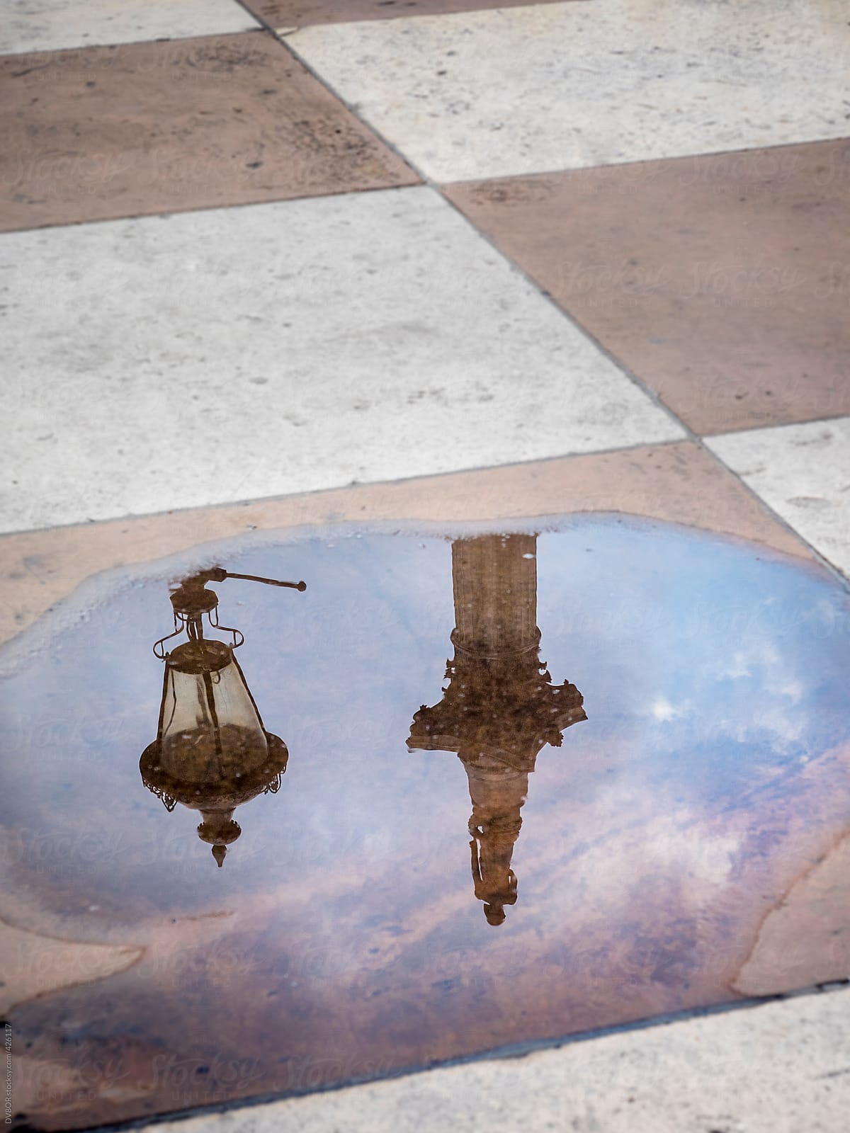 Nelson\'s Column in Trafalgar square, London, England reflected in a puddle