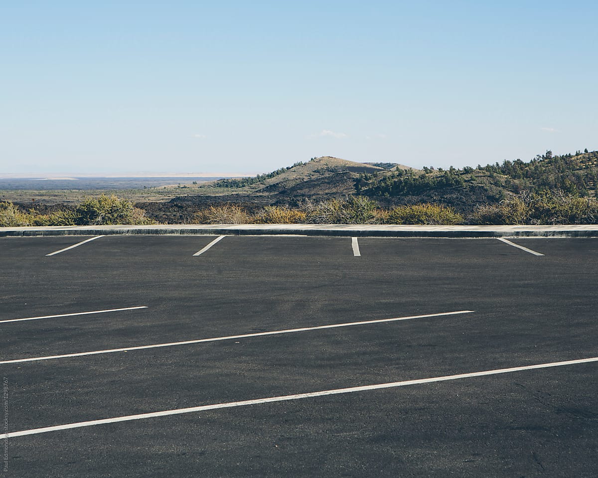 Empty parking lot, lava field in distance