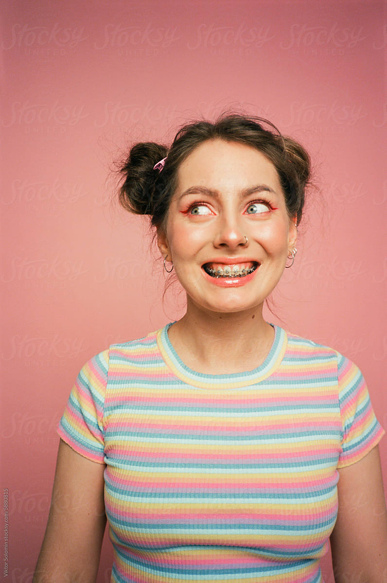 Smiling young woman in casual wear. Funny girl with braces