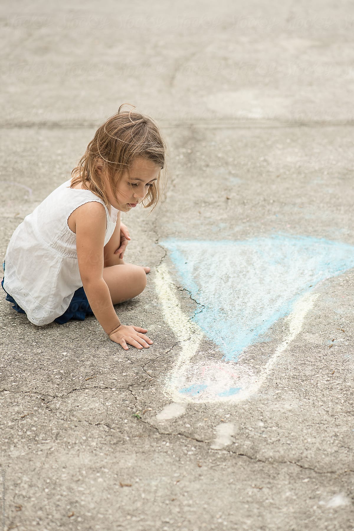 A Girl Looks At Her Chalk Drawing