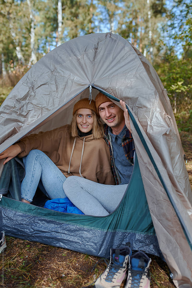 man and woman in tent on hike in nature forest park