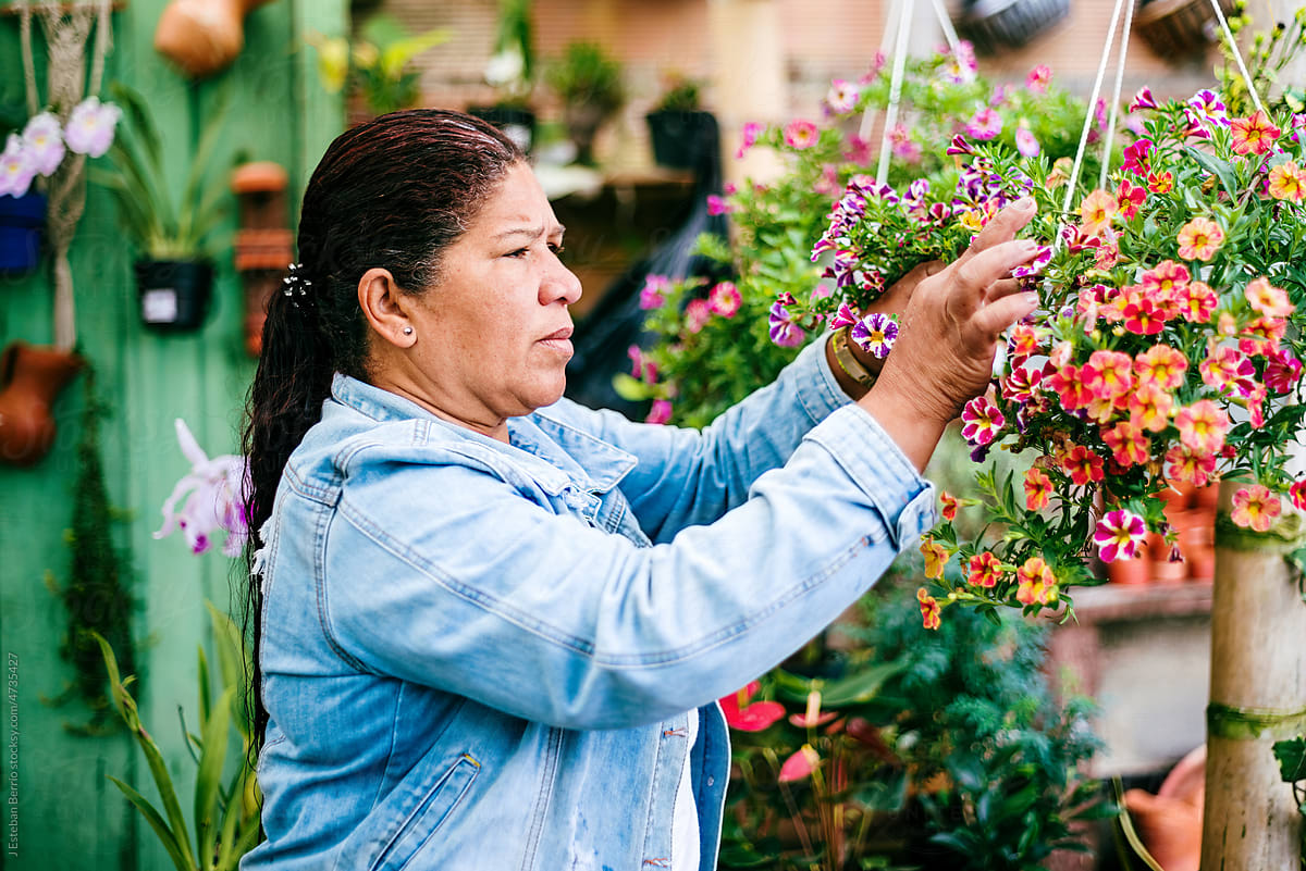 Businesswoman examining the flowers in her business