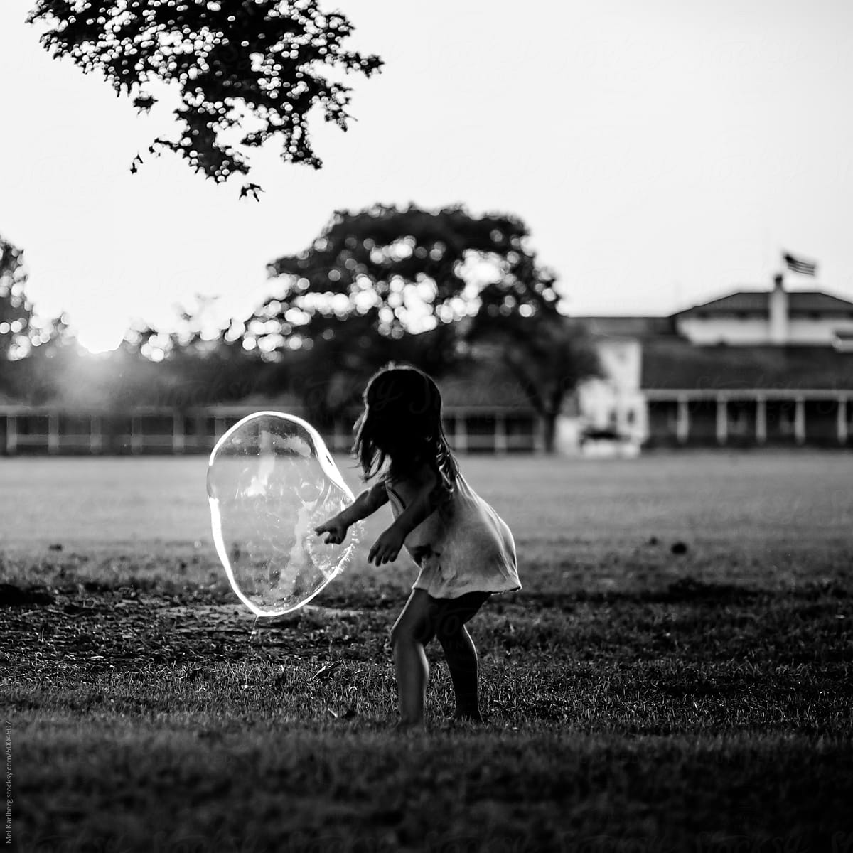 Girl popping giant bubble