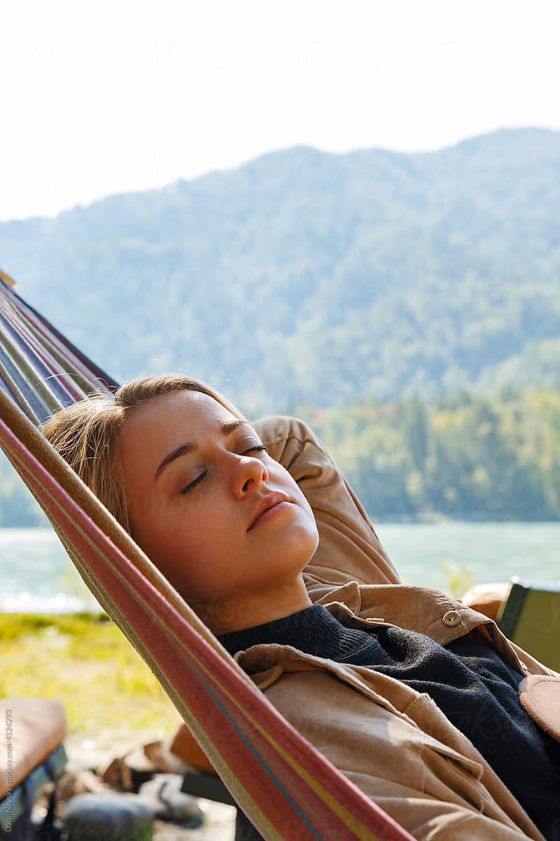 Relaxed woman lying on hammock in nature