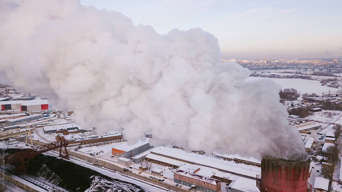 Smoke from industrial pipe over winter city