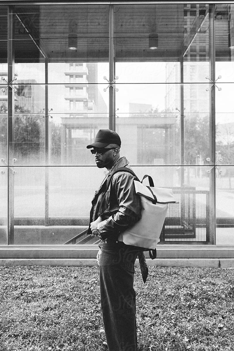 Stylish Urban Man Wearing Sunglasses And Leather Jacket With Bag