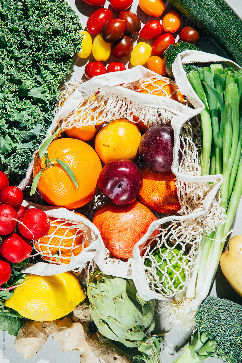 Variety of organic fruits and vegetables on a reusable bag