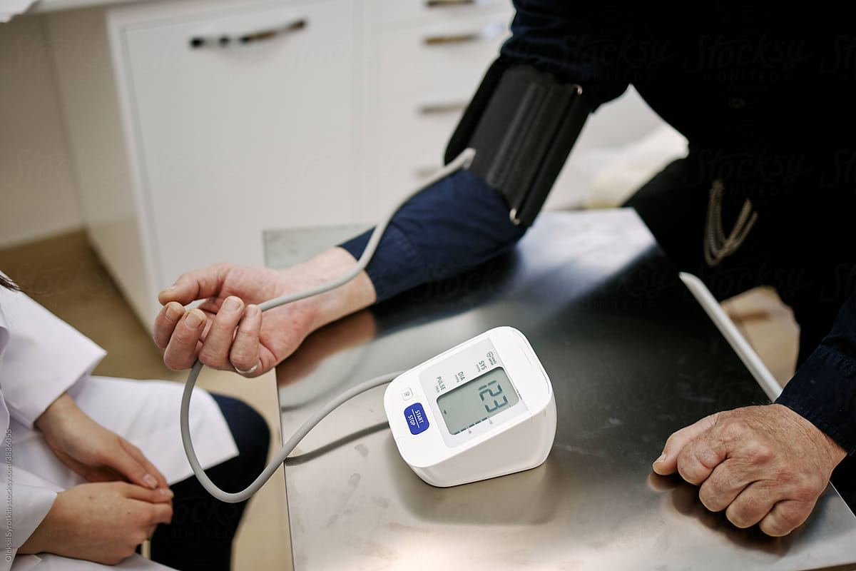 Client Measuring Blood Pressure With Medical Device
