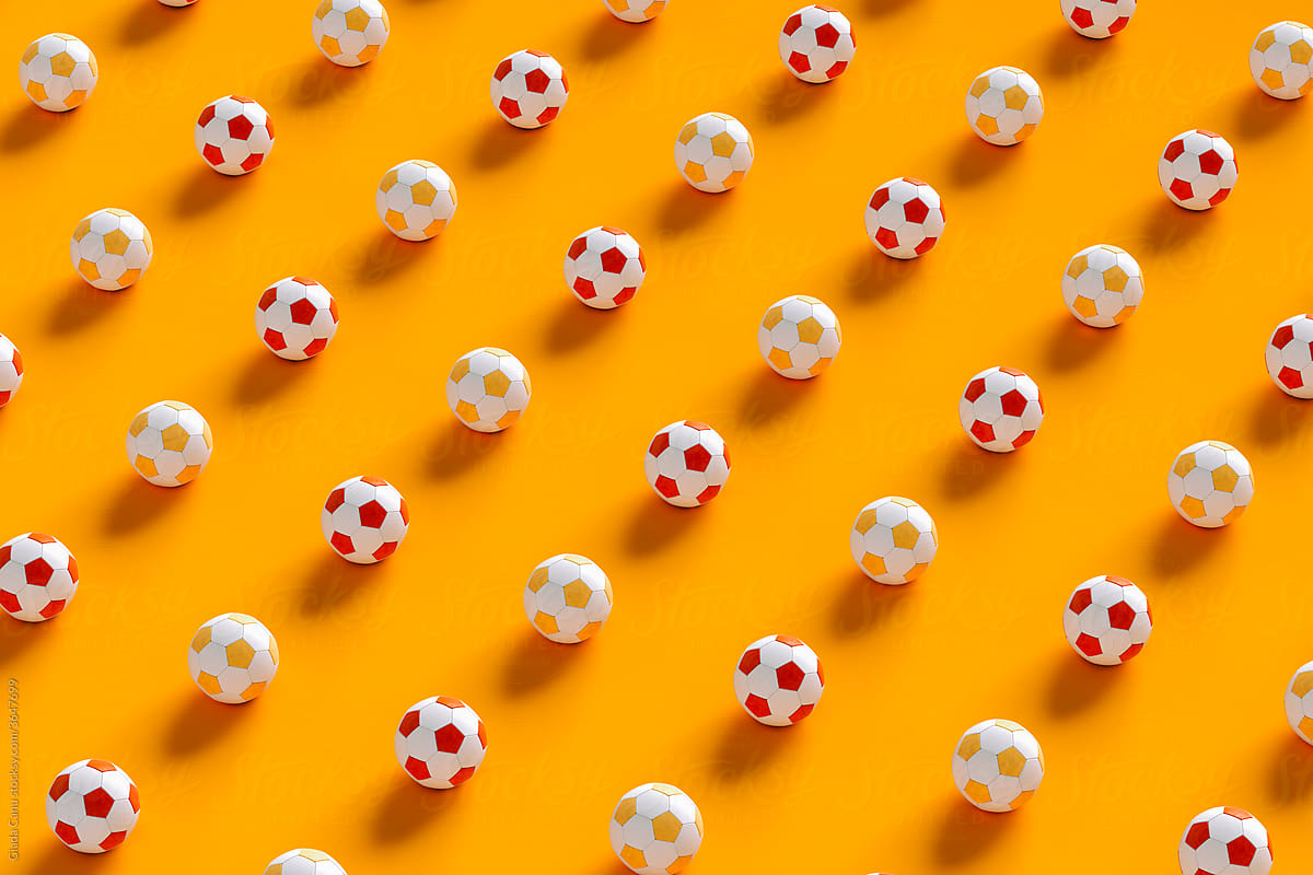 Soccer balls on orange background