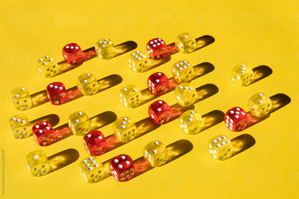 Yellow and red dice on yellow paper