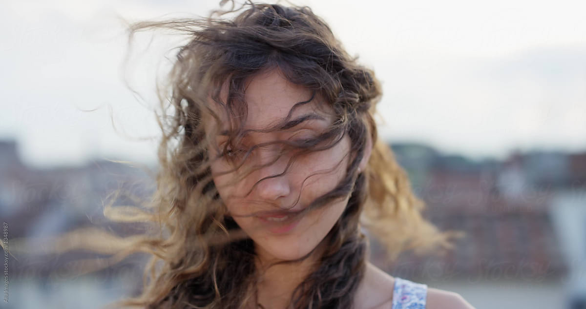 Close Up Portrait Of Beautiful Young Woman Smiling Hair Blowing In Wind Slow Motion By Stocksy 3151
