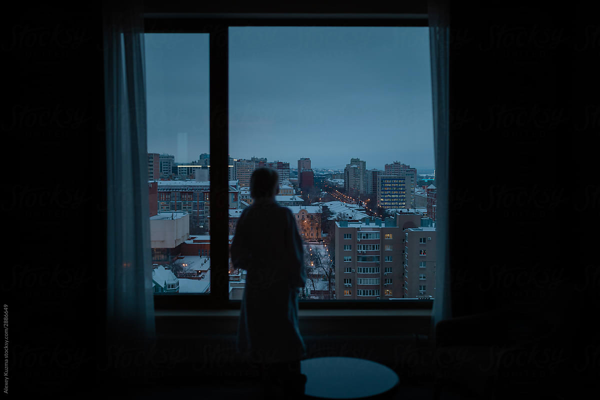 young woman near the window at night
