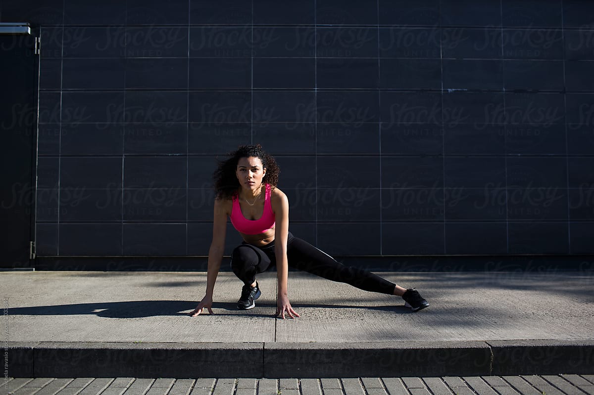 Fit Woman Doing Stretching Outdoors By Stocksy Contributor Michela Ravasio Stocksy