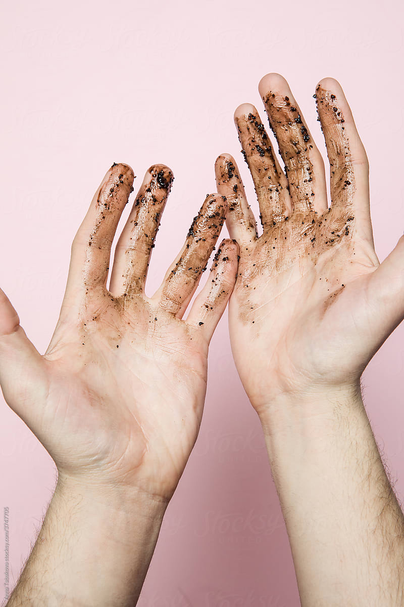 Hands with a face scrub
