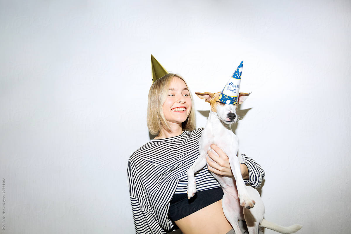 Funny Portrait Of Dog In A Hat And A Female Owner