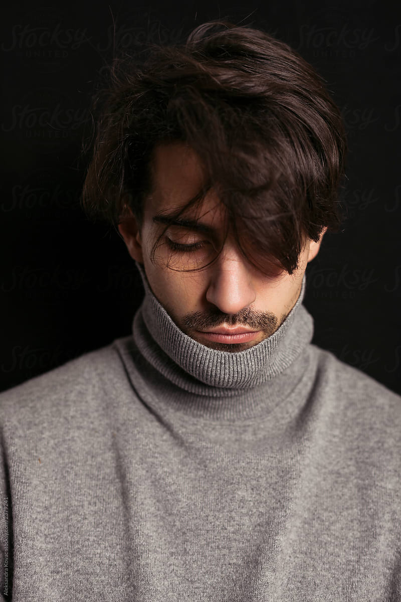 Portrait of a men actor in grey turtleneck sweater